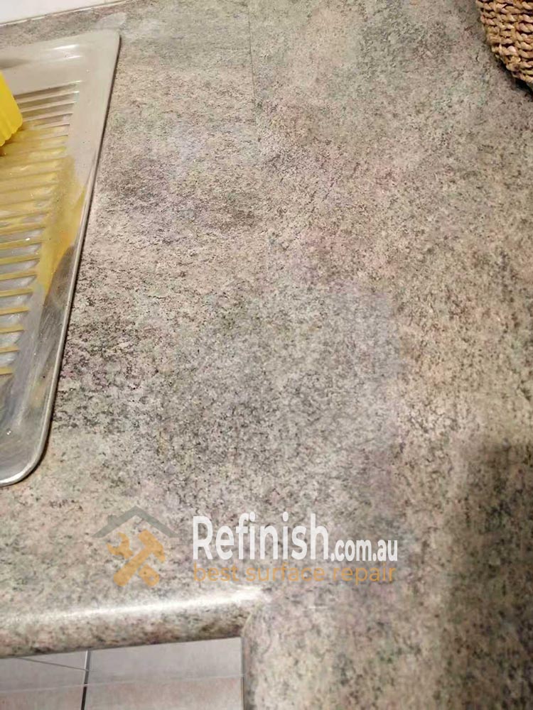 Refinish.com.au specialist performing hand-painted grain matching on a laminate surface in Sydney.